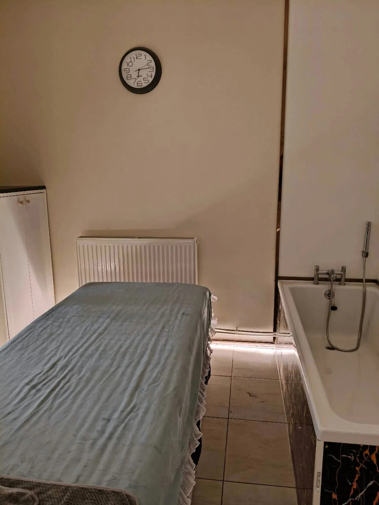 Calm Waters Worthing treatment room with bath and massage table